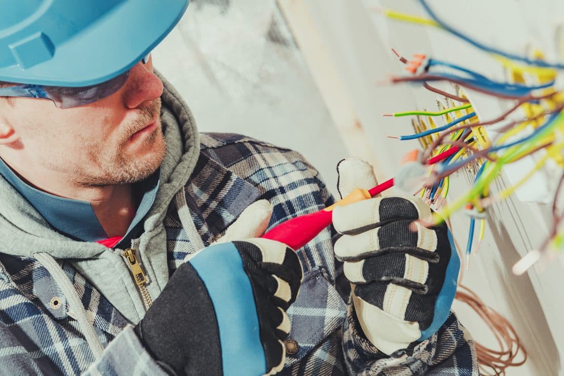 Electrician wiring an outlet